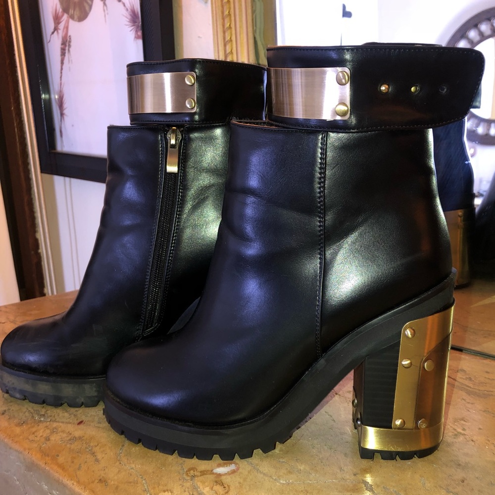 Chunky black leather boots w/ metal heel and strap